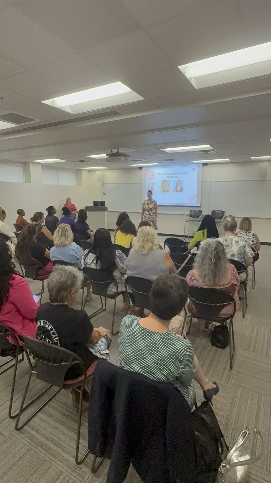 Kristi Nowrouzi presenting to an audience at a public speaking workshop